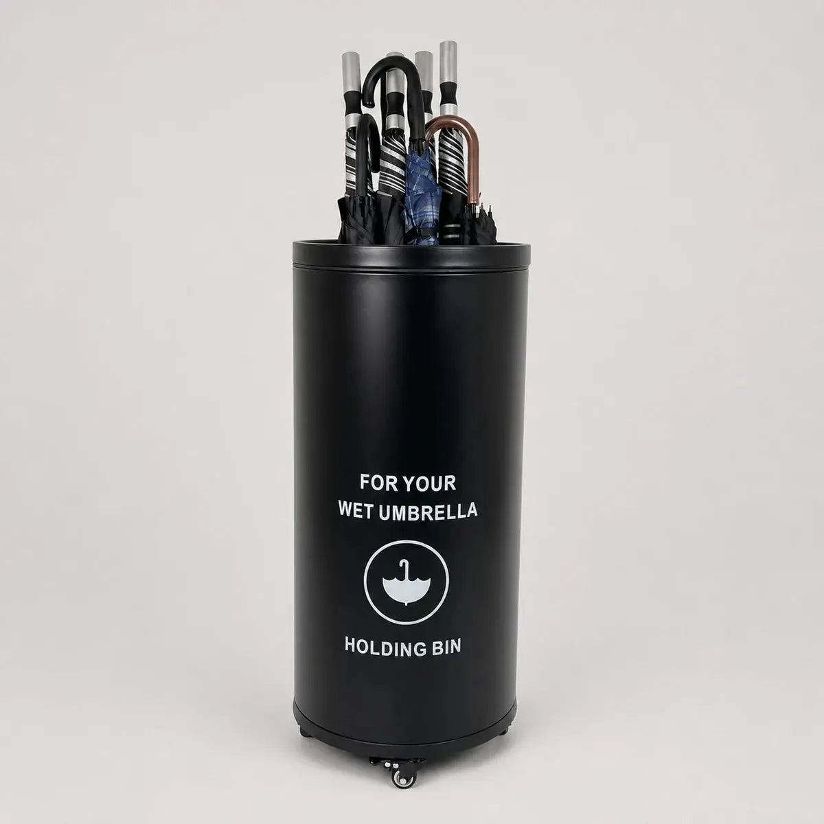 Black umbrella holding bin filled with umbrellas for commercial entrances